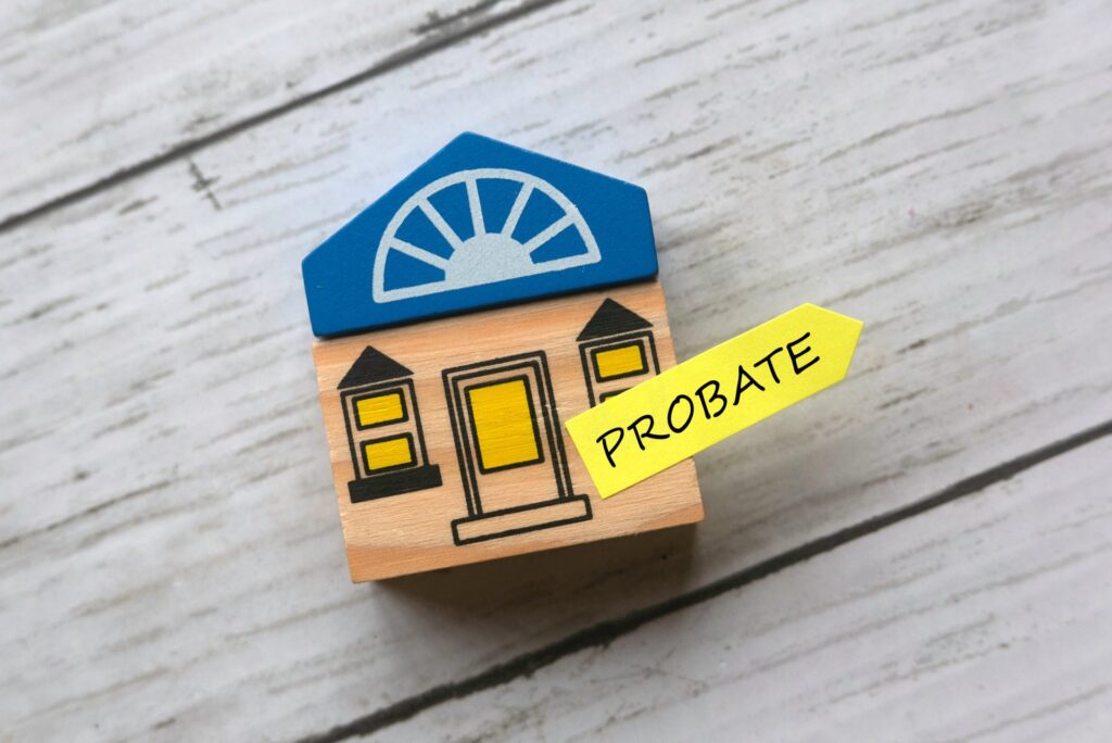 mini wooden house with a sticky note on it that says probate
